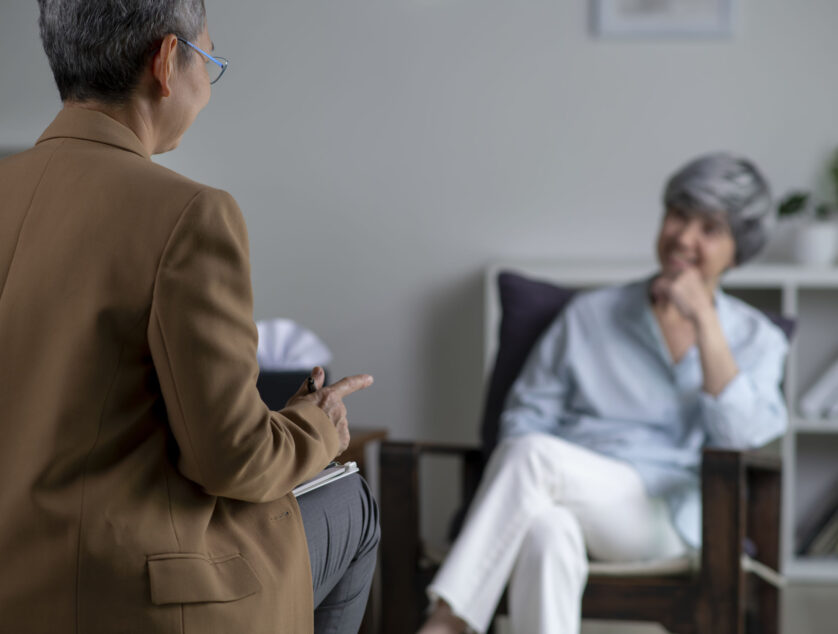 210073032 M Therapist, psychologist talking and counselling to Asian patient at office during psychology treatment.