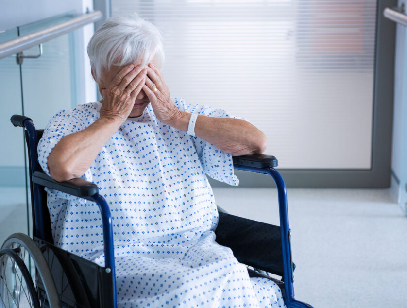 Disabled Senior Patient On Wheelchair In Hospital Passageway Disabled senior patient on wheelchair in hospital passageway at hospital